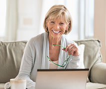 Photo of a woman at a computer. Links to Gifts of Appreciated Securities