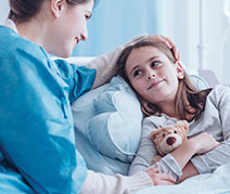 Photo of a child in a hospital bed. Links to Gifts by Will